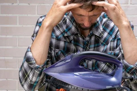 Repairman doesn't know how to fix it. Frustrated master. Stock Photos