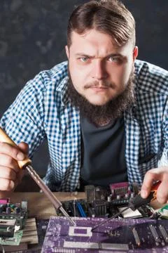 Repairman fixing problem with soldering tool Stock Photos