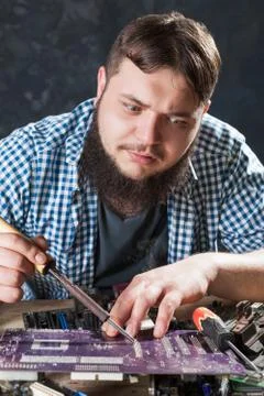 Repairman fixing problem with soldering tool Stock Photos