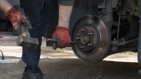Repairman hammer on the car drive to replace it with a new one Stock-Footage 108975827