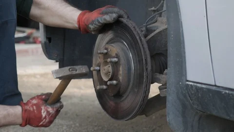 Repairman hammer on the car drive to replace it with a new one Stock Footage 108976248