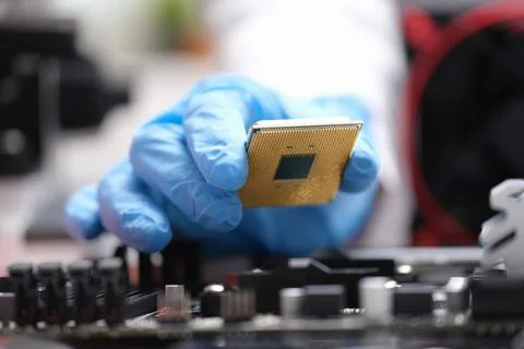 Repairman installing computer processor into motherboard closeup 写真素材
