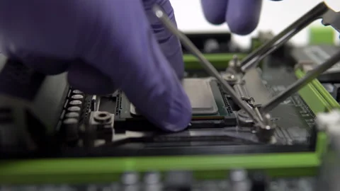 The repairman installs the main processor into the socket. Maintenance and Stock Footage 151903055