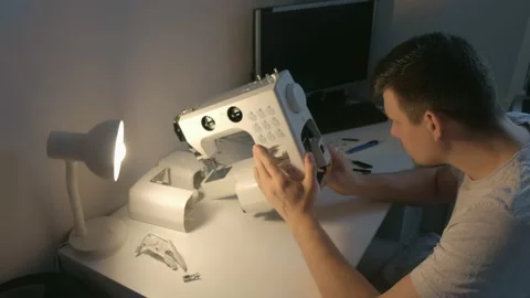 Repairman master is collecting and testing sewing machine after repairing. Stock Footage 137162042