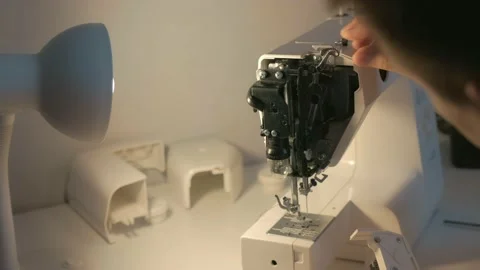 Repairman master is collecting and testing sewing machine after repairing. Stock Footage 137694265