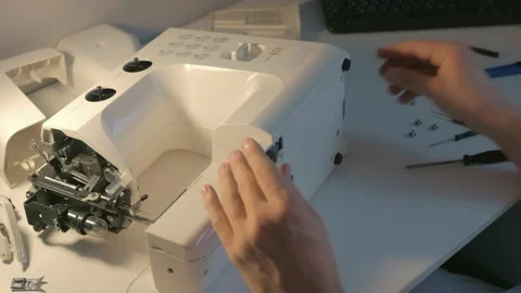 Repairman master is collecting and testing sewing machine after repairing. Stock Footage 146165569