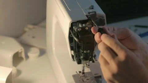 Repairman master is collecting and testing sewing machine after repairing. Video stock 153413822