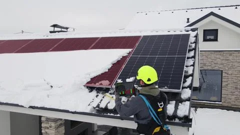 Repairman with modern tablet detecting error on solar panels Stock Photos
