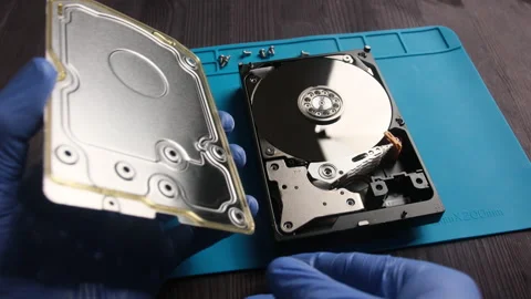 Repairman opens computer hard disk drive to fix in service center Stock Footage 276113711