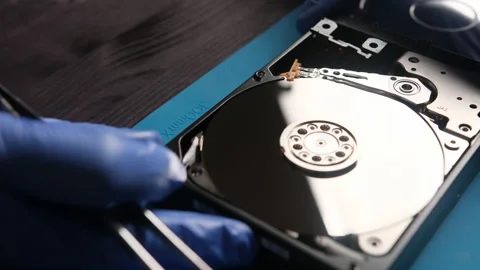 Repairman opens computer hard disk drive to fix in service center Stock Footage 314000912