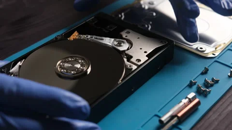 Repairman opens computer hard disk drive to fix in service center Stock Footage 339007158