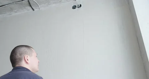 Repairman puts putty on wall for smooth texture. Smoothes out all irregularities Stock Footage 130428513