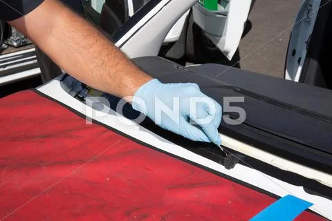 Repairman is repairing windshield of the car Stock Photos