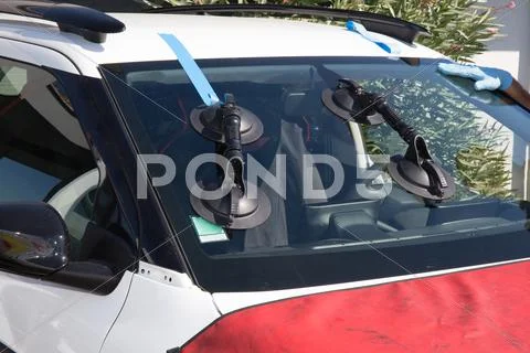 Repairman is repairing windshield of the car Stock Photos