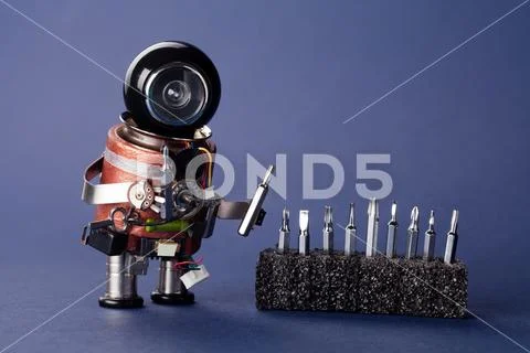 Repairman robot with screwdriver set. Fun toy character, black helmet head and Stock Photos