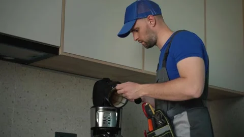Repairman with screwdriver fixing coffee machine at indoors 動画素材 252660583