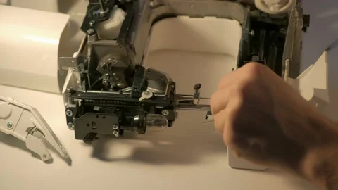 Repairman testing disassembles sewing machine in workshop repairing it. Video stock 153085786