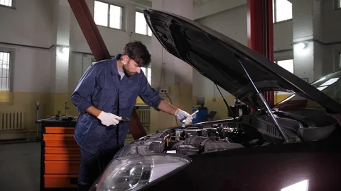 Repairman using wrench while replacing oil filter Stock Footage 123505013