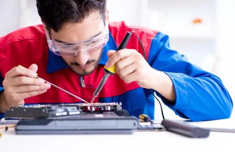 Repairman working in technical support fixing computer laptop tr Stock Photos