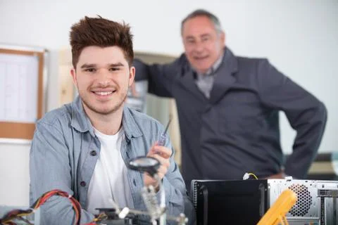 Repairman working in technical support fixing computer laptop tr Stock Photos