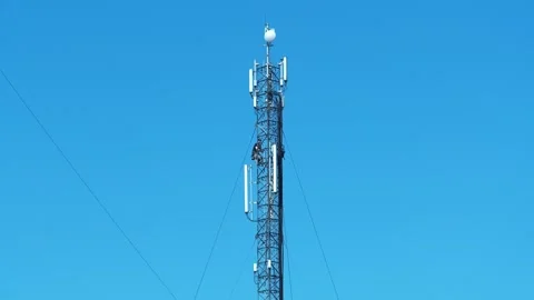 Repairmen service a cell tower, install new cable and equipment Stock Footage 321194974