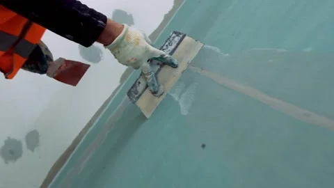 Repairs. The man is applying plaster, on plasterboard Video stock 88953342
