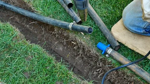Reparing Damaged Underground Irrigation System In Lawn 動画素材 115736122