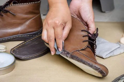 Reparing the torn boots Stock Photos