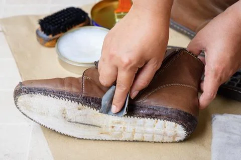 Reparing the torn boots Foto stock