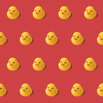 Repeatable pattern of yellow rubber duck on red background Modern style. crea Stock Photos