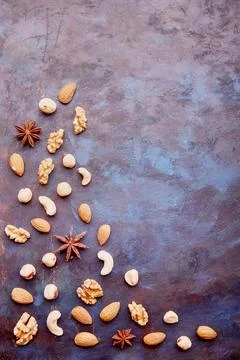 Repeated pattern with assorted nuts on rustic background. Hazelnuts , walnuts Stock Photos