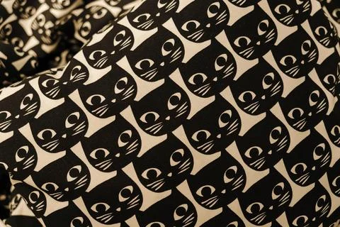 Repeating black cat illustration pattern on decorative fabric. Stylish Stock Photos