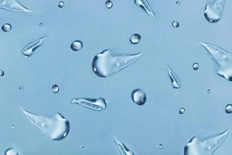 Repeating cosmetic gel smears on blue background Stock Photos