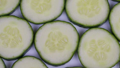 Repeating cucumber pattern. Dewy cucumber slices arranged in perfect repeated pa Stock Footage 332786849