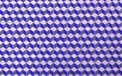 Repeating geometric patterns of cubes on the floor of ceramic tile. Stock Photos