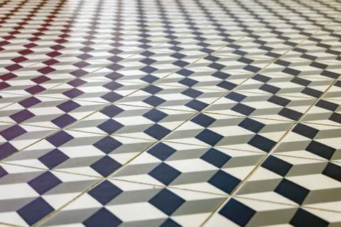 Repeating geometric patterns of dice on the floor of ceramic tile. Stock Photos