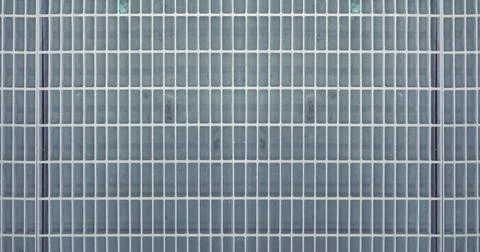 Repeating Metal Grid Pattern Background With Symmetrical Industrial Texture Stock-Fotos