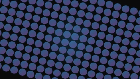 A repeating pattern of blue circles arranged in a uniform grid on black Stock Footage 339615356