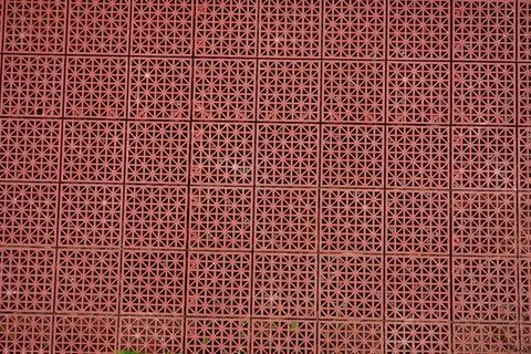 A repeating pattern of red plastic tiles Stock Photos