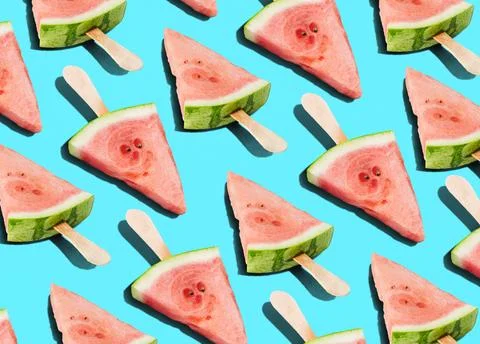 Repeating Pattern of Watermelon Popsicles on Bright Blue Background Stock Photos