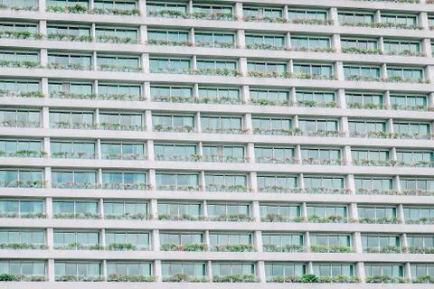 Repeating pattern of windows and balcony for background. Building front Stock-Fotos