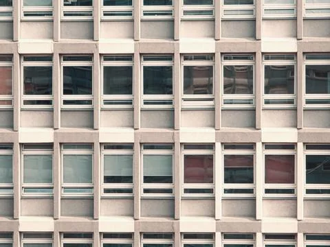 Repeating window grid on concrete facade Stock Photos