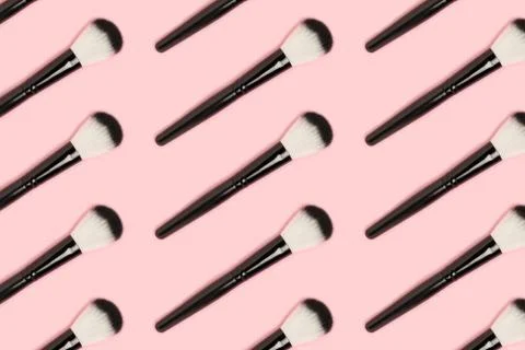 Repetitive pattern made of black makeup brushes. Stock Photos