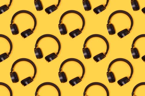 Repetitive pattern made of black wireless headphones. Stock Photos