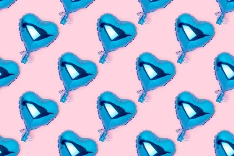 Repetitive pattern made of blue inflatable balloons in a heart shape. Stock Photos