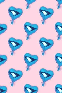 Repetitive pattern made of blue inflatable foil balloons in a heart shape. Stock Photos