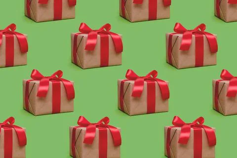 Repetitive pattern made of gift boxes tied with red ribbons Stock Photos