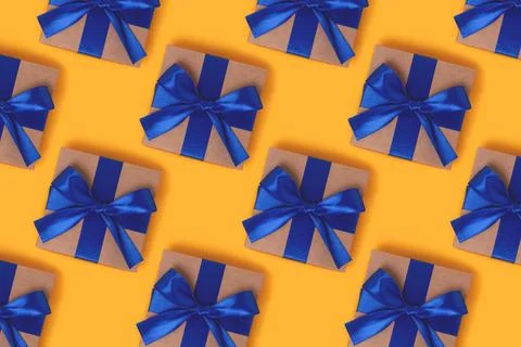 Repetitive pattern made from gift boxes with blue ribbons. Stock Photos