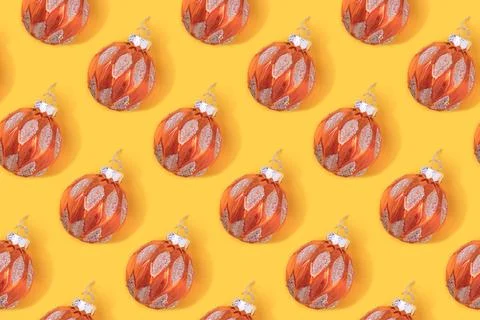 Repetitive pattern made of gold colored Christmas baubles. Stock Photos