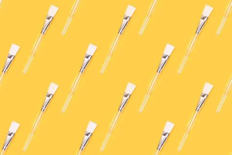 Repetitive pattern made of makeup brush with transparent handle. Stock Photos